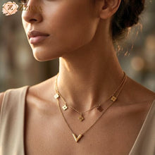 Close-up of a woman wearing a gold necklace with a blurred background by zzilya fashion