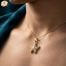 Gold starfish pendant necklace on a person's neck with 'ZZIYA' branding.