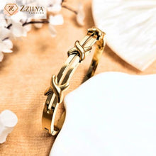 Crossed gold bangle bracelets for women