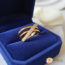 Gold ring with diamonds in a blue jewelry box, featuring the Zzilya brand.