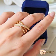A gold-plated stainless steel triple infinity ring with interlocking stone-studded rows.