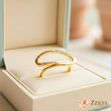 Zzilya Fashion Gold Sculptural Oval Ring with pavé crystal accents worn on a hand, showing a modern minimalist jewelry design.