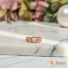 Rose gold ring with diamonds on a marble surface, Zzilya Fashion brand visible