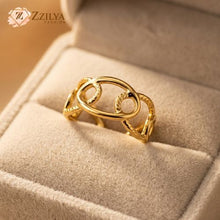 Close-up of a woman's hand wearing a Zzilya Fashion gold interlocking link adjustable ring, minimalist stackable jewelry aesthetic.