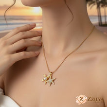 Woman wearing a gold necklace with a starfish pendant on a beach at sunset. ZZILYA-Starfish-Anti-Tarnish-Gold-Necklace-Beach-Jewelry