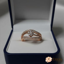 Close-up of a Zzilya anti-tarnish rose gold ring featuring a central crystal flower and two curved pavé bands in a modern wave design.