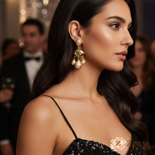 Woman wearing elegant earrings with a blurred background by zzilya