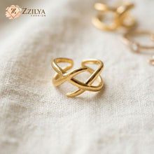 Gold ring with a textured surface on a beige fabric background, featuring the brand 'ZZILYA'.