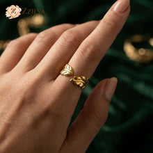 Gold ring on a finger with a blurred green background by zzilya fashion