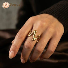 Minimalist chunky liquid gold wave ring on a hand, anti-tarnish stainless steel jewelry for women by Zzilya fashion jewellery