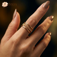 Gold ring on a finger with a blurred background and 'Zzilya' branding.