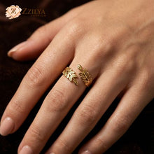 Gold leaf ring on a hand with Zzilya Fashion logo in the corner.