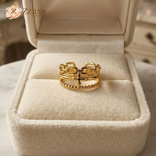 Gold ring in a beige jewelry box with Zzilya branding.
