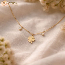 Gold necklace with a clover pendant on a soft fabric background by zzilya fashion