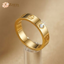 Gold ring with a diamond on a beige background, featuring the brand 'ZZILYA'.