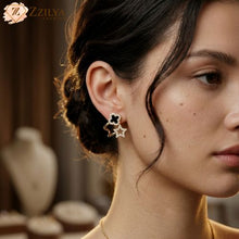 Close-up of a woman wearing star-shaped earrings with a blurred background
