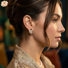 Close-up of a woman wearing a sparkling swan earring with a blurred background by Zzilya fashion