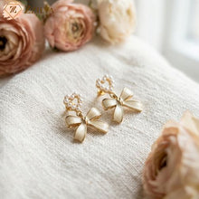 Gold bow-shaped earrings with pearl details on a textured surface with pink flowers by zzilya fashion
Top Quality Under ₹99!
The Best Seller is Back.