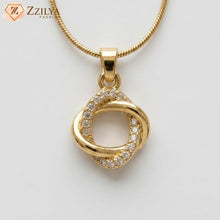 Gold pendant with diamonds on a white background, branded 'ZZILYA'.