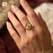 Golden Clover ring on a hand with a blurred background by zzilya Fashion