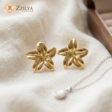 Close-up of a large polished golden flower-shaped stud earrings by zzilya Fashion.
