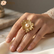 Golden sun design ring with pearl on a hand, brand 'Zzilya Fashion visible
