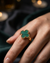 Close-up of a hand wearing a gold four-leaf Green clover ring by zzilya fashion jewellery