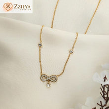 Gold necklace with an infinity symbol pendant on a beige background, featuring the brand 'Zzilya'.