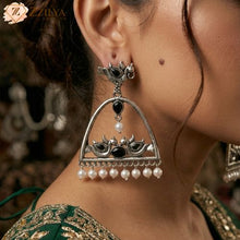 Elegant silver earring with black stones and pearl-like beads worn by a person by Zzilya Fashion