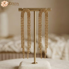 Gold beaded earrings on a display stand with 'Zzilya Fashion' branding.