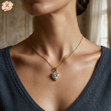 Gold necklace with a diamond Heart pendant worn by a person, with a blurred background by Zzilya fashion