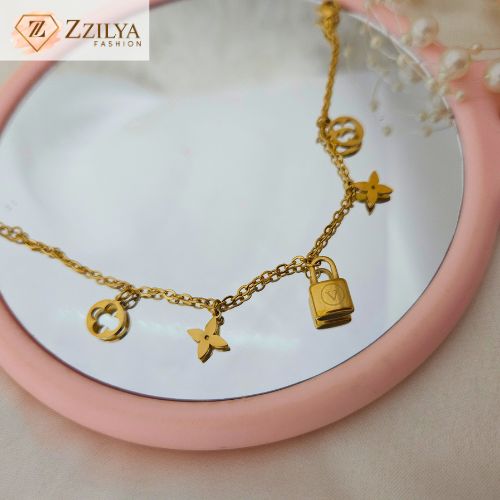 Elegant gold charm bracelet by Zzilya Fashion featuring lock and clover charms – anti-tarnish and hypoallergenic jewelry.
