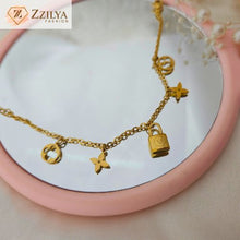 Elegant gold charm bracelet by Zzilya Fashion featuring lock and clover charms – anti-tarnish and hypoallergenic jewelry.