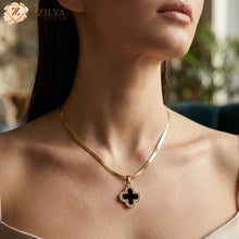 Gold necklace with a black pendant worn by a model, brand 'ZZILYA' visible.