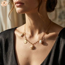 Beach Anti tarnish Necklace with shell and pearl charms worn by a person, with a blurred background by Zzilya fashion