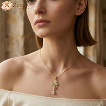 Woman wearing a golden butterfly stone studded necklace with a pendant, brand 'Zzilya fashion' visible
