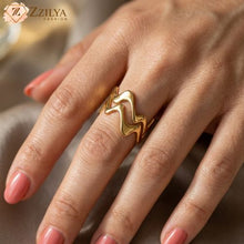 Golden anti tarnish minimalist ring on a hand with a blurred background, featuring the brand 'Zzilya Fashion'.