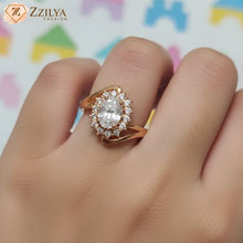 Zzilya Fashion rose gold tarnish-free ring featuring a large oval center stone surrounded by a sparkling crystal halo on a bypass band.
