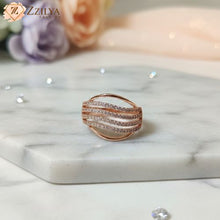 Close-up of a Zzilya rose gold adjustable ring featuring five delicate multi-layered bands studded with micro-crystals on a woman's finger.