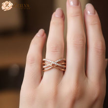 Close-up of a woman wearing a Zzilya rose gold plated anti-tarnish ring with a sparkling criss-cross cubic zirconia design.