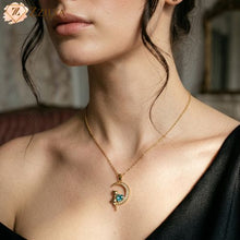 Zzilya Fashion anti-tarnish gold twisted neckchain featuring a crescent moon pendant with a gold cat sitting next to a heart-shaped teal crystal.