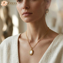 Model wearing an anti-tarnish gold twisted neckchain with an oval mother-of-pearl pendant from ZZILYA Fashion.