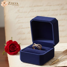 Blue jewelry box with a ring inside, next to a red rose on an old letter, with 'Zzilya Fashion' branding.