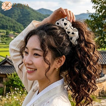 Woman with styled hair wearing a hair accessory in a scenic outdoor setting