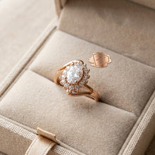 Rose gold ring with a large diamond in a beige jewelry box