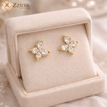 Pair of Zzilya Fashion golden anti-tarnish butterfly stud earrings with sparkling teardrop crystals, displayed in a premium cream velvet jewelry box.
