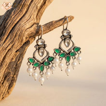 Lightweight green stone oxidised dangle earrings with pearls hanging on a rustic wooden branch, aesthetic daily wear office jewelry from Zzilya Fashion.