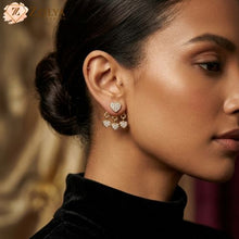 Close-up of a woman wearing heart-shaped earrings with hangings under rs 99 by zzilya fashion