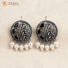 Round oxidised silver metal earrings with black stone accents and hanging white pearls by Zzilya Fashion.