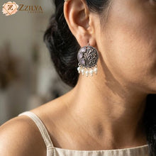 Model wearing a round lightweight oxidised silver earring with lavender stone accents and small pearl drops from Zzilya Fashion.